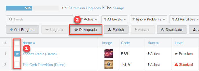 Screenshot of program page. Highlighted is a checkmark in a box next to a program. This is labeled with a number 1. The number 2 is above a highlighted button labeled Downgrade. 